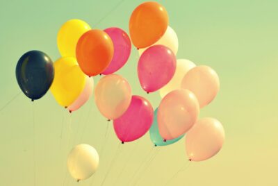 Colourful balloons floating upwards